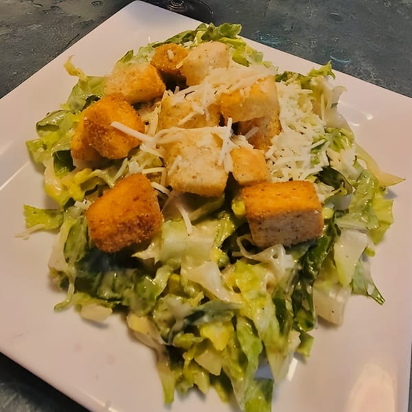 A Caesar salad from Mama's Italian Family Restaurant, with crisp lettuce, croutons, and shredded cheese.