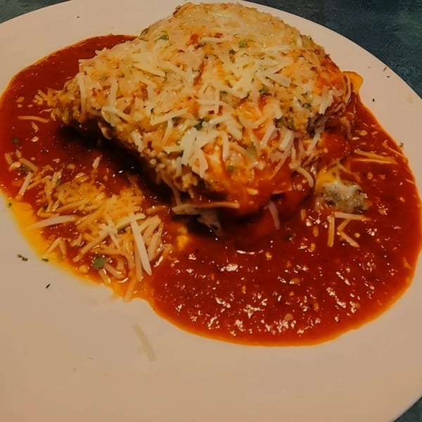 Mama's Italian Family Restaurant's lasagna, topped with melted cheese and rich red sauce.