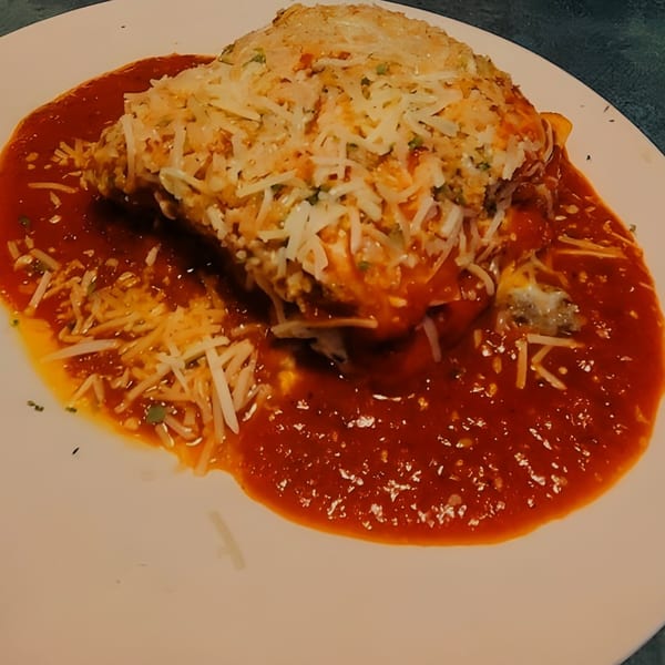 Mama's Italian Family Restaurant's baked lasagna, topped with melted cheese and rich red sauce.